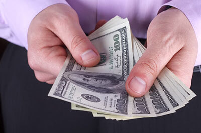 man holding hundred-dollar bills